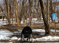 person in wheelchair in melting snow